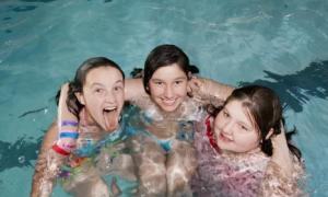 Three girls playing in pool.